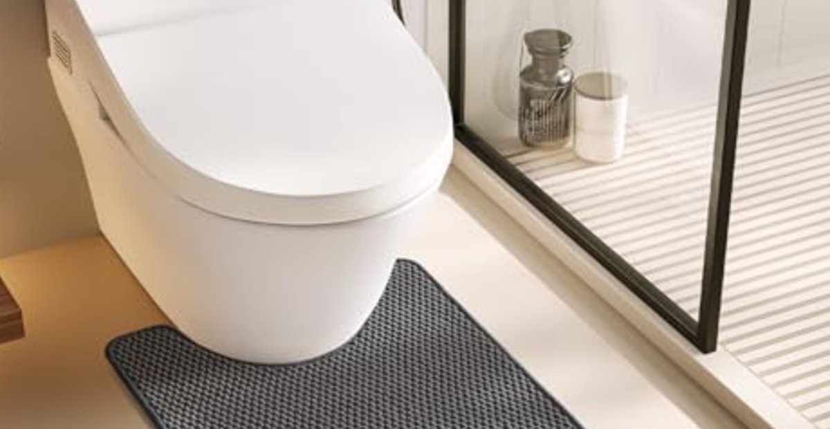 A U-shaped TYUU contour rug fitted around the base of a toilet